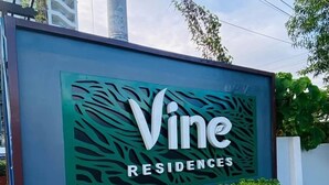 A sign for Vine Residences with a modern design and greenery. - Fabulous 2-bedroom condo unit in Quezon (Quezon)
