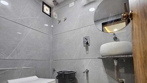 A modern bathroom with a toilet, bidet, and sink. - HOTEL GATEWAY INN (Ahmedabad)