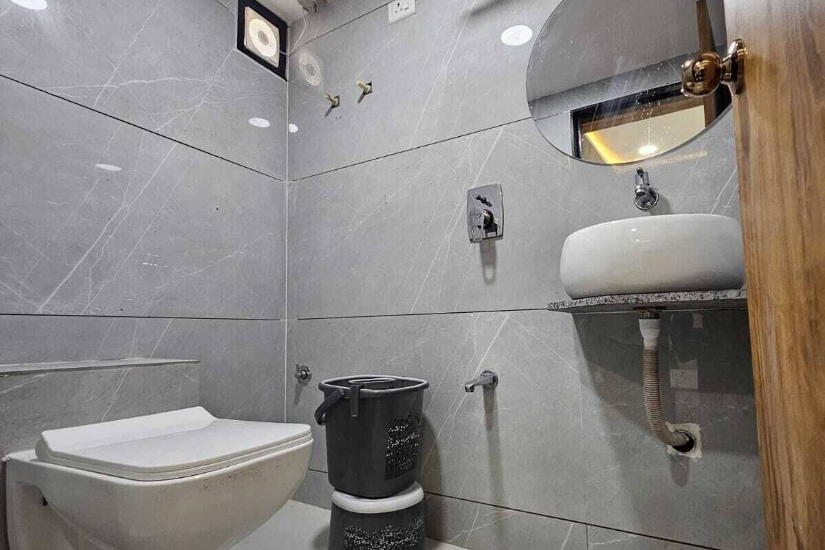 A modern bathroom with a toilet, bidet, and sink.