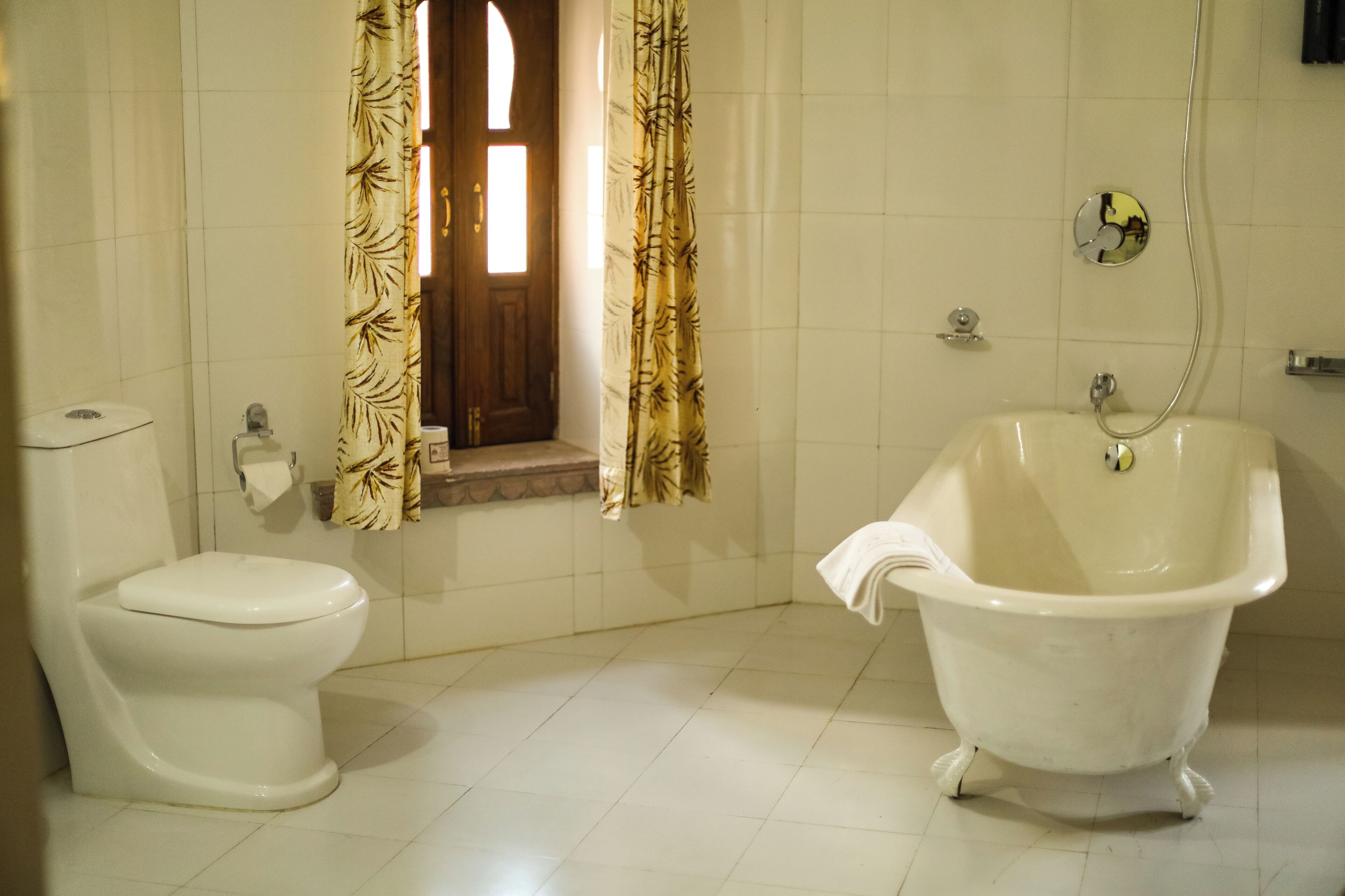 A bathroom with a toilet, a bathtub, and a shower.