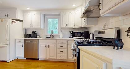 Charming coastal home near pond with sunroom, open layout, yard & AC