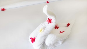 A towel with red flowers and a butterfly. - The Gili Menjangan (Pejarakan)