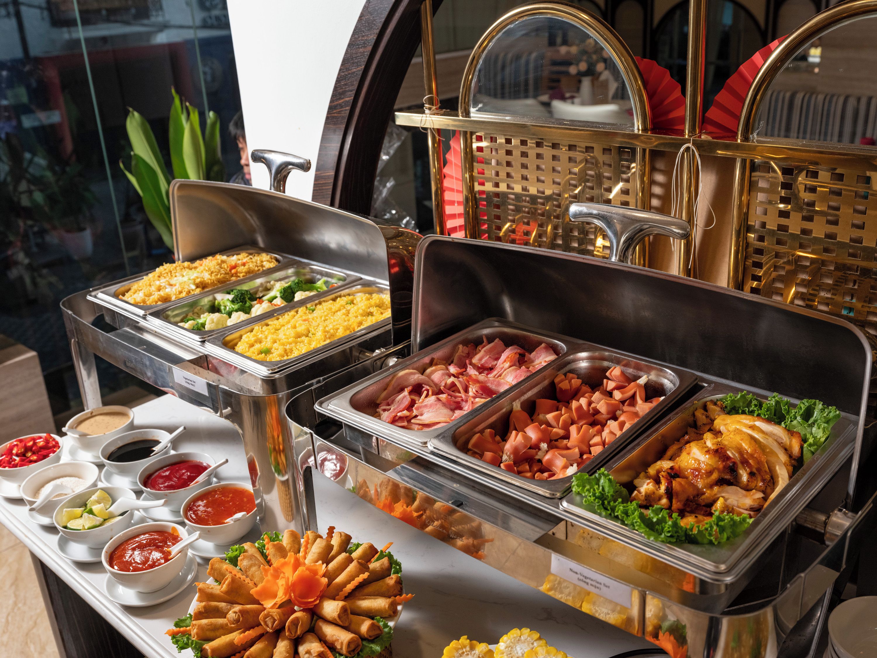 A buffet with various food options including rice, meats, and vegetables.