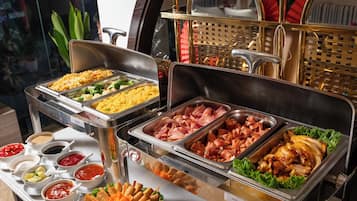 A buffet with various food options including rice, meats, and vegetables.