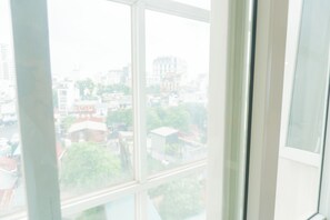 Habitación cuádruple presidencial, no fumadores, vistas a la ciudad | Ropa de cama de alta calidad y colchones con acolchado adicional