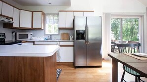 A modern kitchen with a large island, stainless steel appliances, and a view of the outdoors. - Your Best Vacation is waiting at the Sage Chalet - Close to Kalahari & Camelback (Long Pond)
