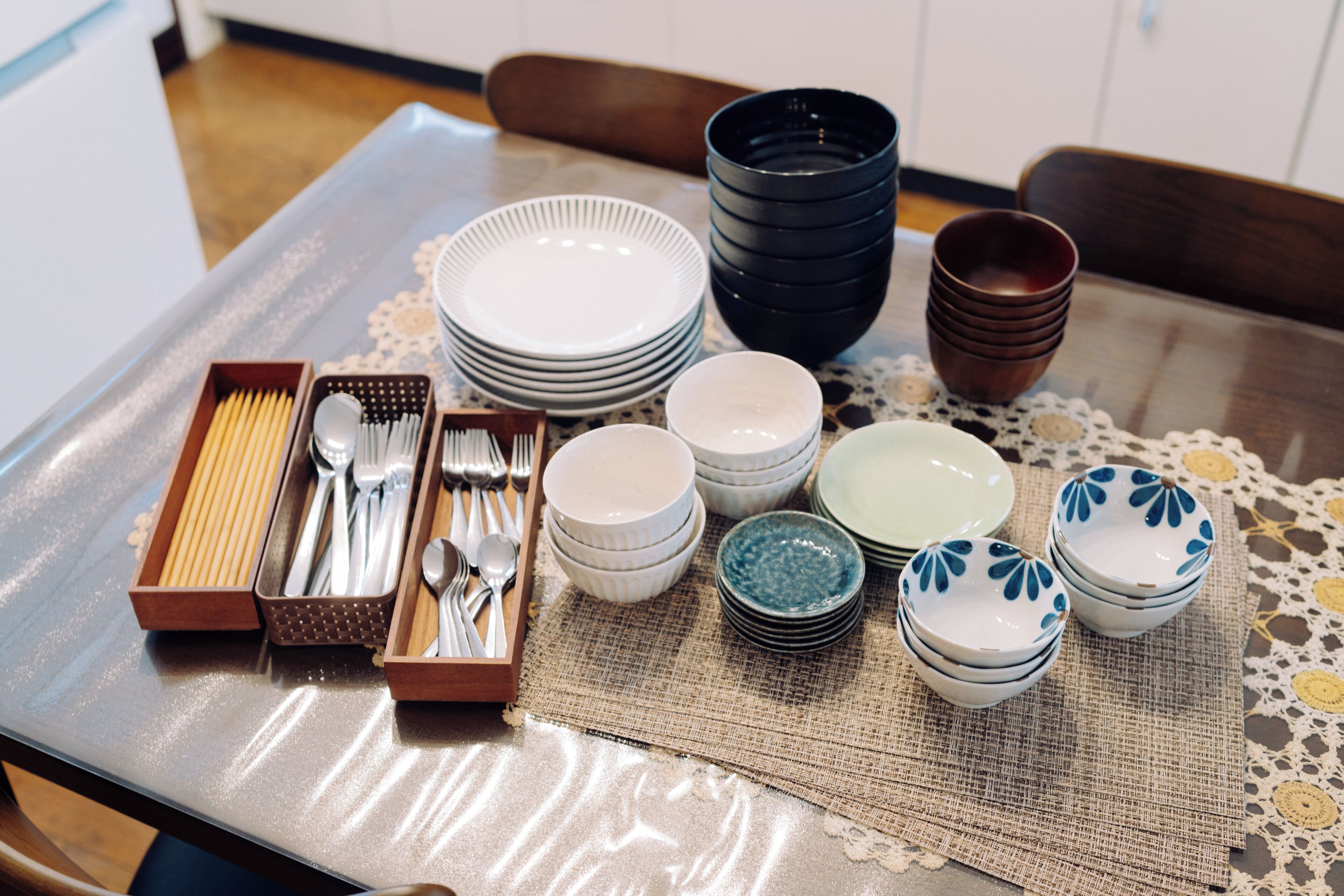 A dining table set with plates, bowls, and cutlery.