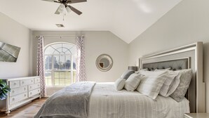 A bedroom with a bed, dresser, and a ceiling fan. - < 1 Mi to Oak Tree National: Cozy Getaway! (Edmond)