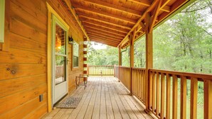 A wooden deck with a railing, a door, and a window. - On 30 Acres w/ Trails & Garden: Stockholm Cabin! (Stockholm)