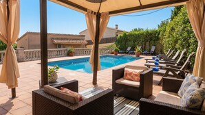 A covered outdoor area with a pool, lounge chairs, and wicker furniture. - 15 minutes by car / Sitges – Villa Ilus. XXL Pool, A/C by Weekly Villas 12 P (Sitges)