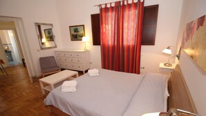 A neatly arranged bedroom with a bed, bedside table, lamp, chair, and a dresser. - Frederick the Second B&B (Palermo)