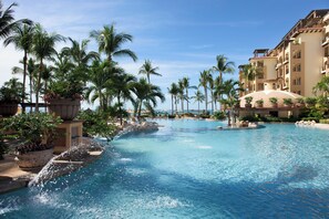 A large, clear swimming pool surrounded by palm trees and a multi-story hotel building. - Beachside Escape at Riviera Nayarit w Pool (Nuevo Nayarit)