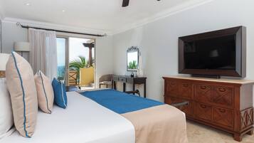 A hotel room with a bed, a dresser, a television, a desk, and a chair.