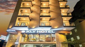 A modern hotel with a unique angular facade, multiple balconies, and a well-lit entrance. - KLY Hotel Vung Tau (Ho Chi Minh City)