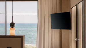 A modern room with a large window, a flat-screen TV, and a minimalist design. - Onora Villa, Steps from the Sea by etouri (Chania)