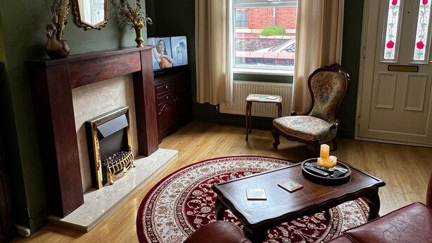 A living room with a fireplace, a television, a chair, and a coffee table. - Robin’S Hollow: 2Bd Home Near Wrexham Afc (Wrexham)