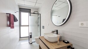 Shower, hair dryer, towels, toilet paper