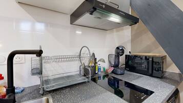 Fridge, microwave, coffee/tea maker, cookware/dishes/utensils