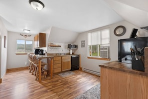 Microwave, dishwasher, coffee/tea maker, dining tables