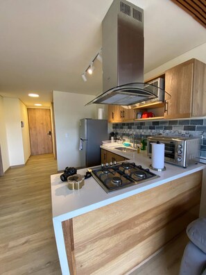 Fridge, microwave, coffee/tea maker, cookware/dishes/utensils