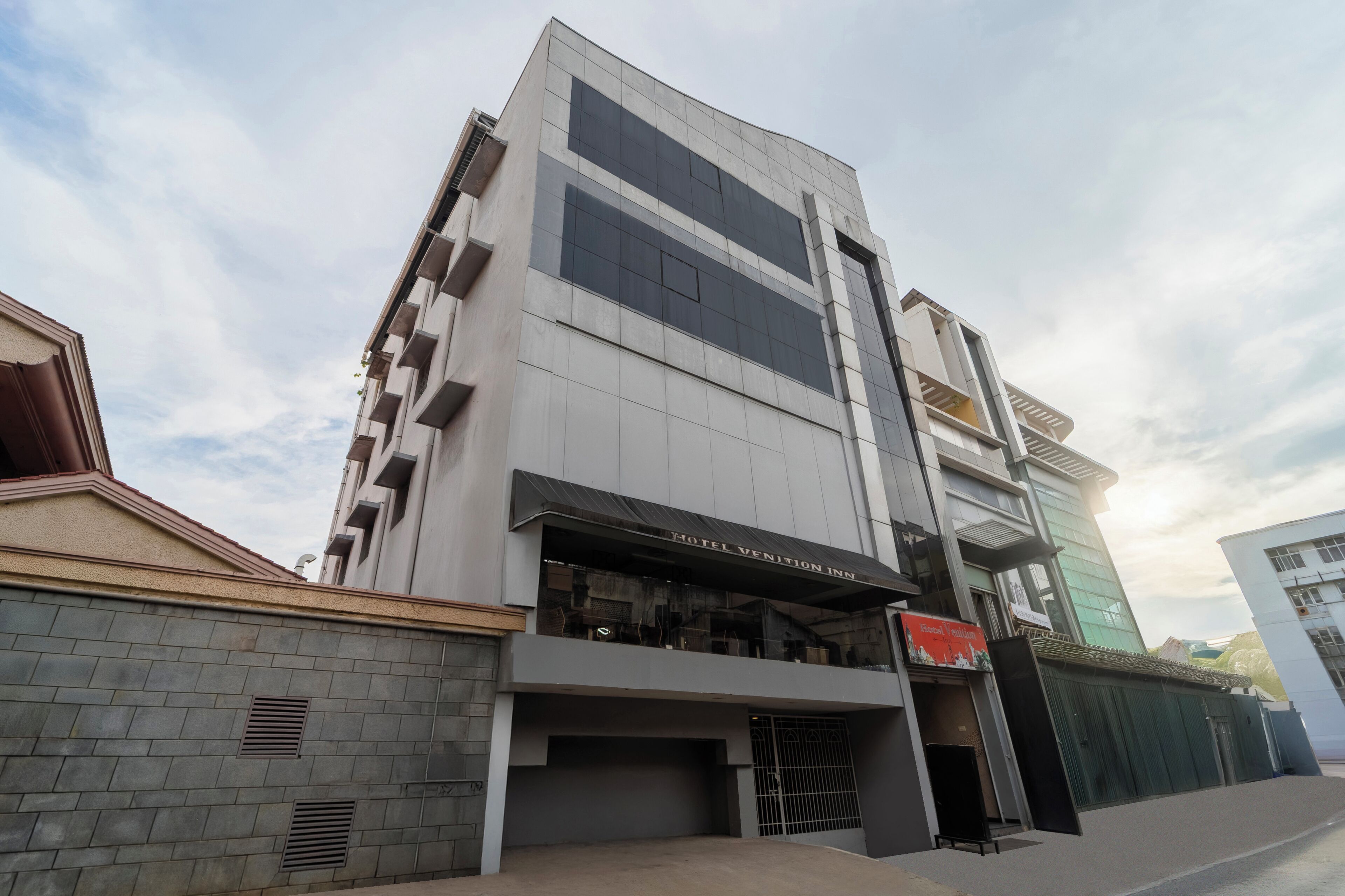 A modern hotel with a prominent entrance and a sign reading "HOTEL VENTION INN".