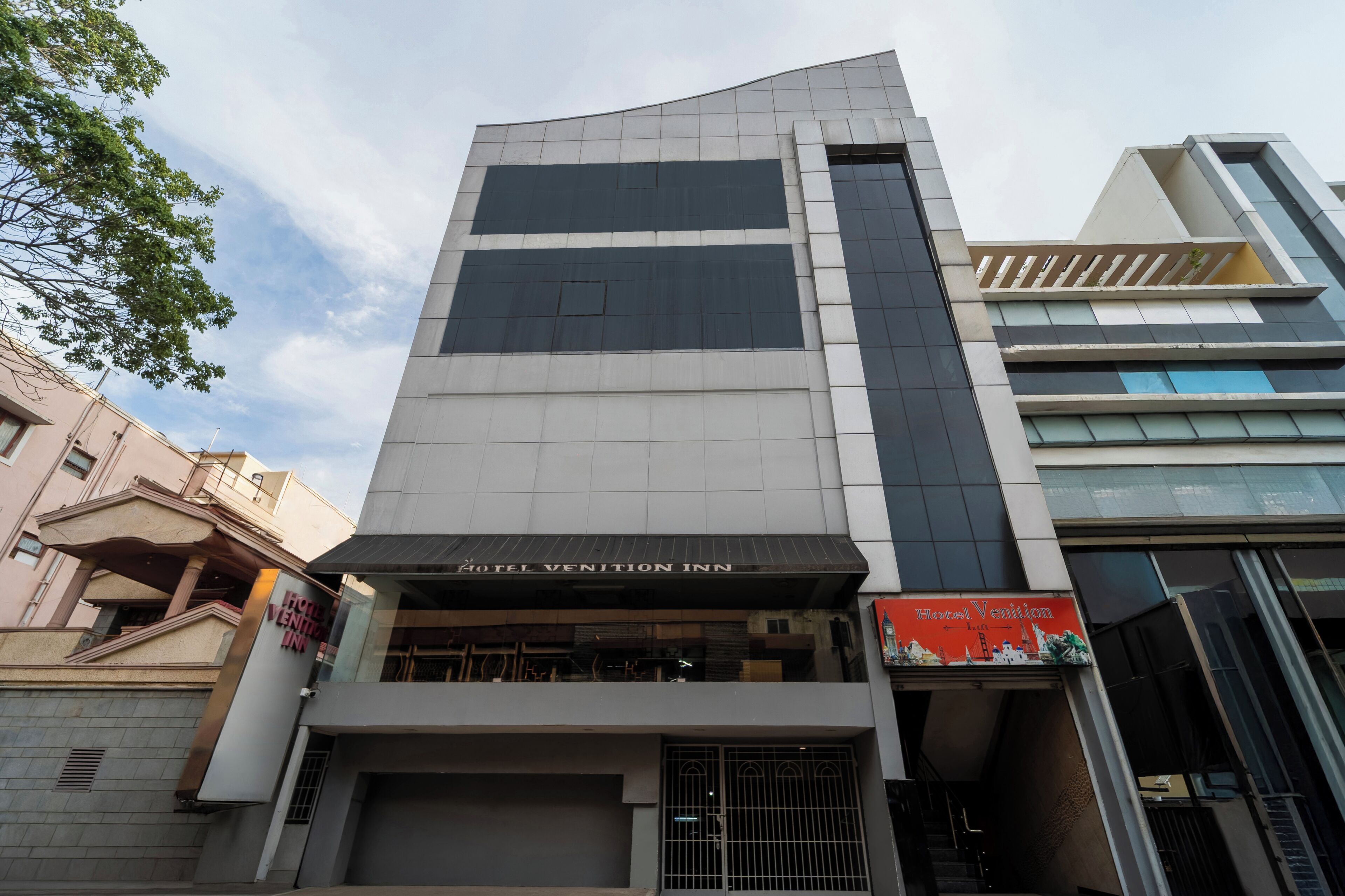 A modern hotel with a prominent sign reading "Hotel Vention Inn."