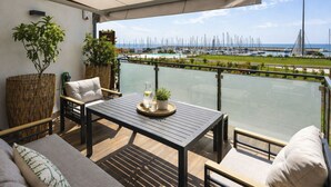 A balcony with a table, chairs, and potted plants. - Entre Bateau et Mer by Interhome (Santo Stefano al Mare)