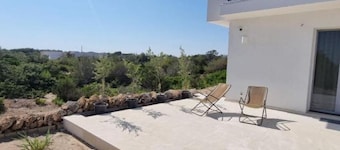 Seafront Juniper apartment with large veranda, 20m from the crystal clear sea.