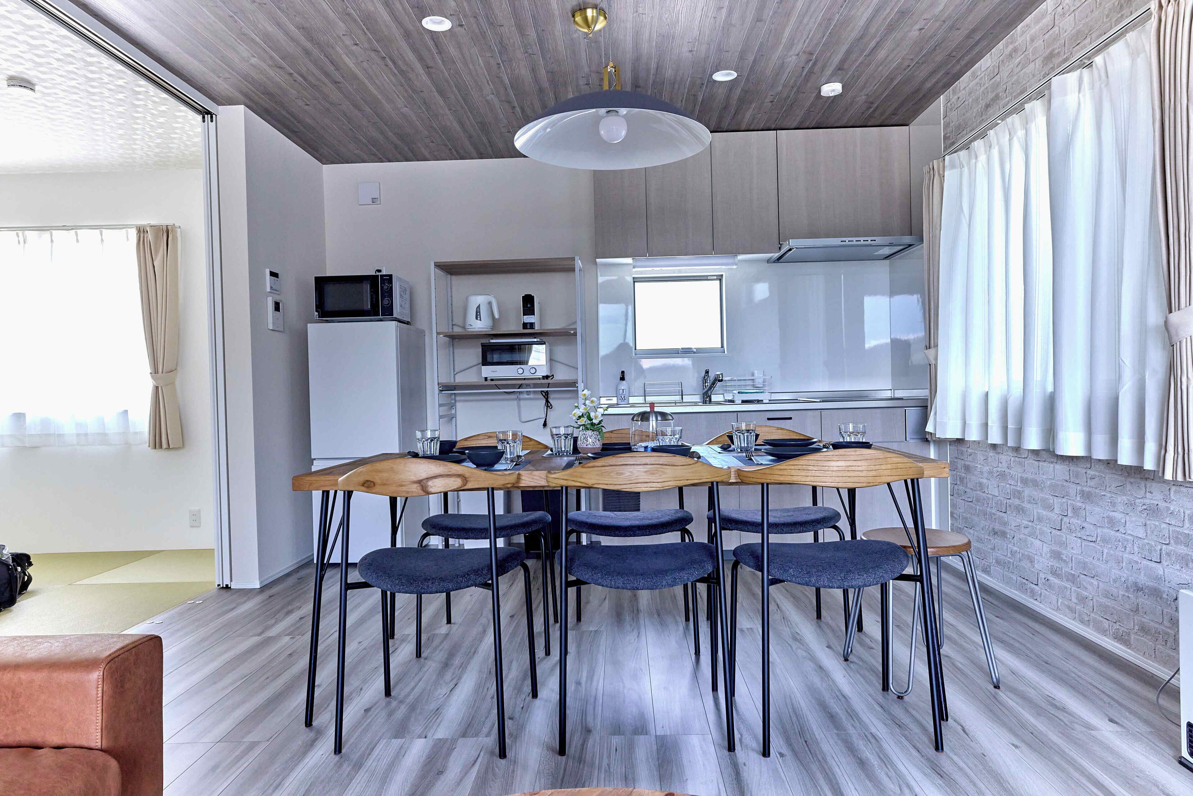 A modern kitchen with a dining area.