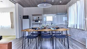 A modern kitchen with a dining area.