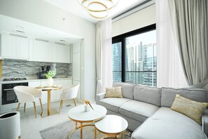 Deluxe Apartment, Lake View | Living area | 65-inch flat-screen TV with digital channels