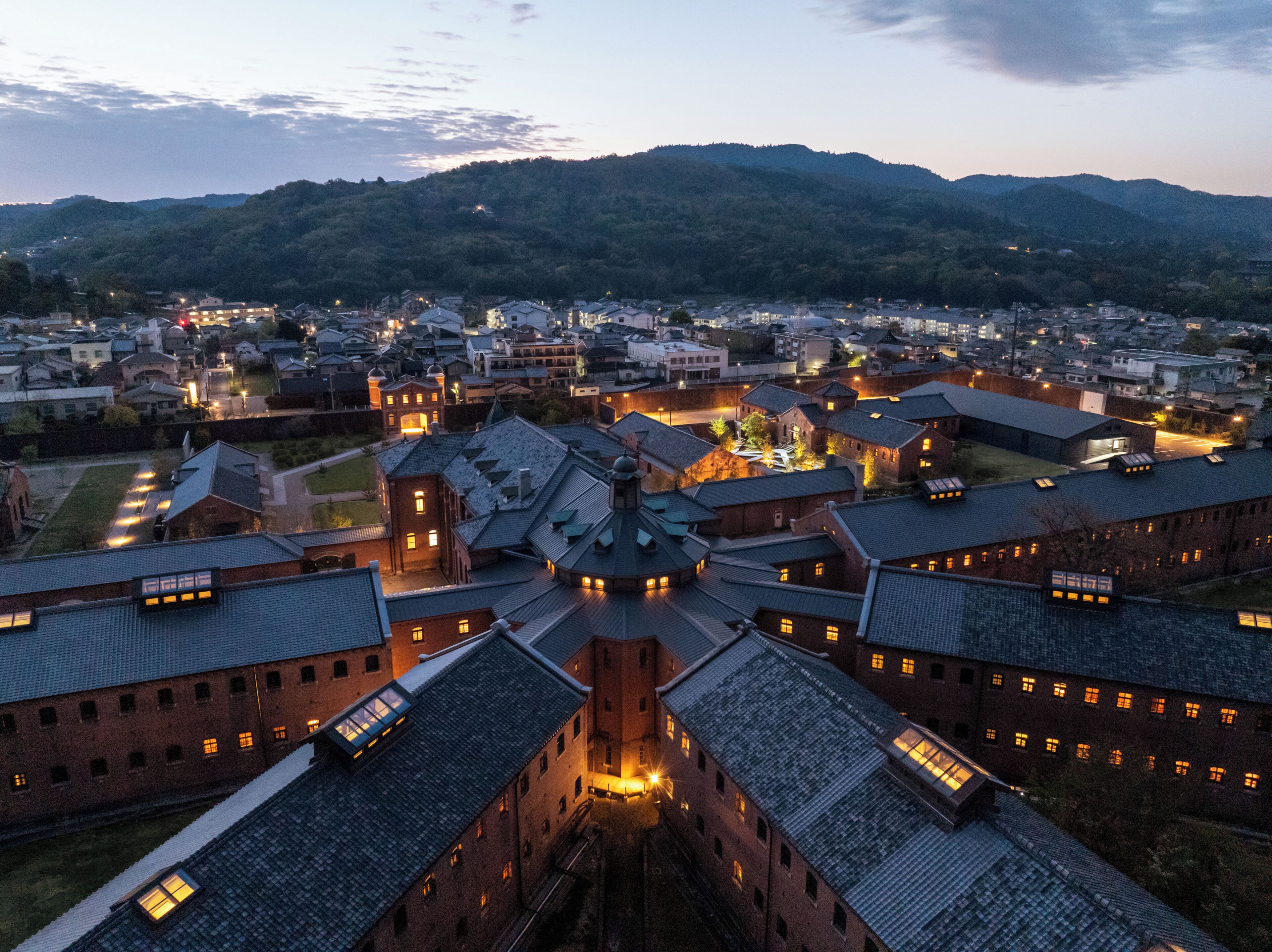 A historic town with traditional architecture, including a central building with a prominent dome and surrounding structures with sloped roofs.