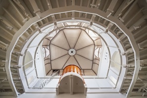 A multi-level interior with a central dome structure, multiple staircases, and a series of balconies. - HOSHINOYA Nara Prison (Nara)