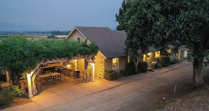 Wake to breathtaking sunrises over the rolling hills! Relax by the fire under the stars, & savor sunset dinners beneath fragrant wisteria pergola. Surrounded by wineries and minutes from historic Jacksonville, this retreat blends charm & convenience
