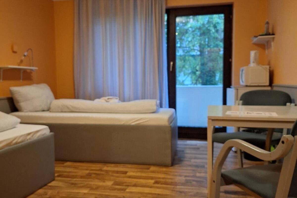 Une chambre d’hôtel avec un lit, un canapé, une table et une chaise.