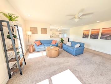 Spacious living room in the upstairs apartment, couch pulls out to queen sized sleeper.