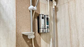 Shower, hair dryer, towels, toilet paper