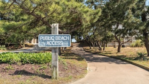 A sign indicating public beach access.