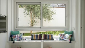 A window seat with colorful cushions and two baskets on the floor. - Addaura Marina Apartment by Wonderful Italy (Palermo)