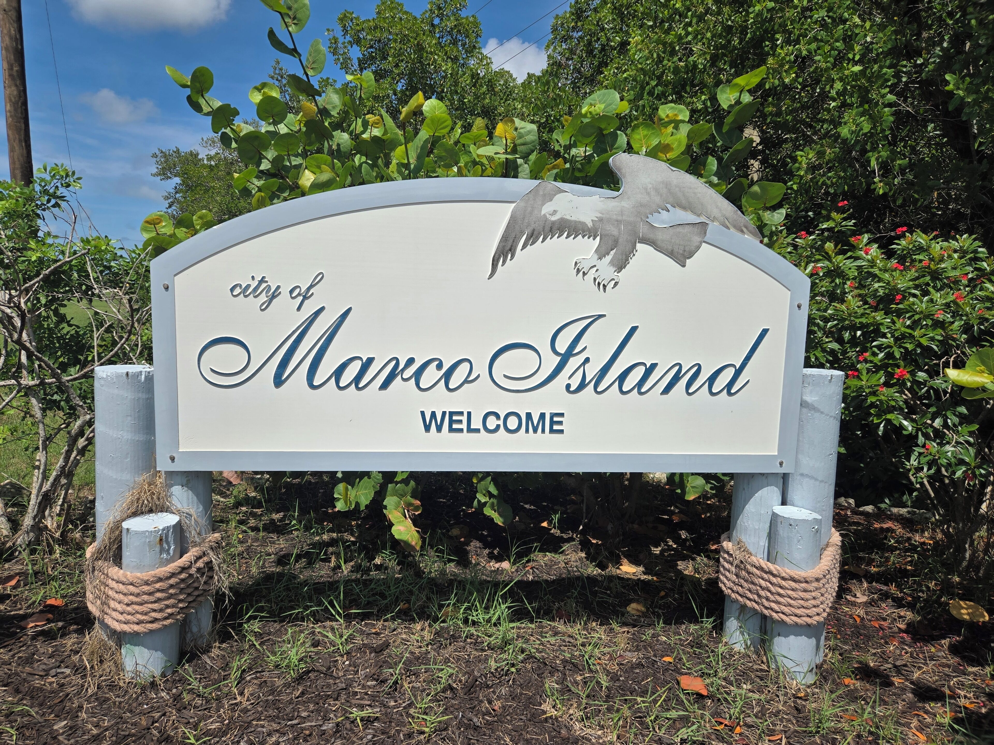 A welcome sign for the city of Marco Island with an eagle graphic.