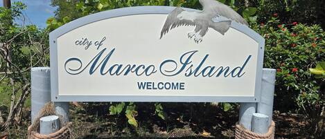 A welcome sign for the city of Marco Island with an eagle graphic.