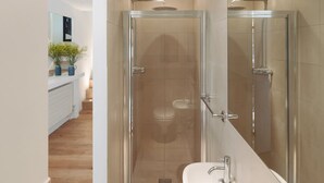 A modern bathroom with a glass-enclosed shower, a white sink, and a mirror. - The Iconic Portobello Mews House (London)