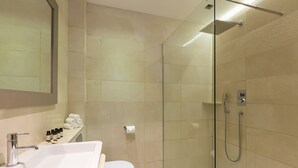 A modern bathroom with a glass-enclosed shower, a white sink, and a toilet. - Modern Times - Covent Garden By Frankie Says (London)