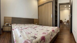 A bedroom with a bed, nightstand, and a wardrobe. - Charming bed & breakfast in delightful Hà Nội with AC, WiFi (Hà Nội)