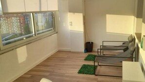 A room with a large window, a bed, a chair, and a small table. - Jolly house 1 (Cosenza)