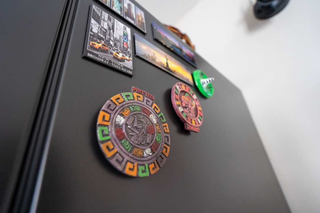 A refrigerator with magnets and photos on it.