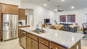 A kitchen with granite countertops, wooden cabinets, and stainless steel appliances. - 9 Mi to Dtwn Bakersfield: Pet-friendly Home (Bakersfield)