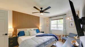 A bedroom with a bed, bedside tables, a ceiling fan, a window with curtains, a chair, and a desk with a lamp. - Waterfront Cedar Creek Lake Gem: Near Marina! (Kemp)