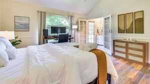 A spacious bedroom with a large bed, a desk, and a view of the outdoors. - Clovis Family Home: Private Pool, Near Old Town! (Clovis)