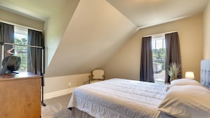 A bedroom with a bed, a dresser, a chair, and a window with curtains. - Hixton Getaway: Near Lakes & Trails! (Hixton)